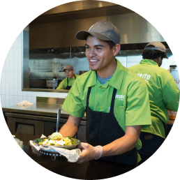 An Uberrito Mexican franchise staff holding a plate of food.